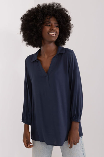 Chic navy everyday blouse by Sublevel, featuring a heart neckline and elegant pre-wrist sleeves, complemented by light wash jeans for a refined look.