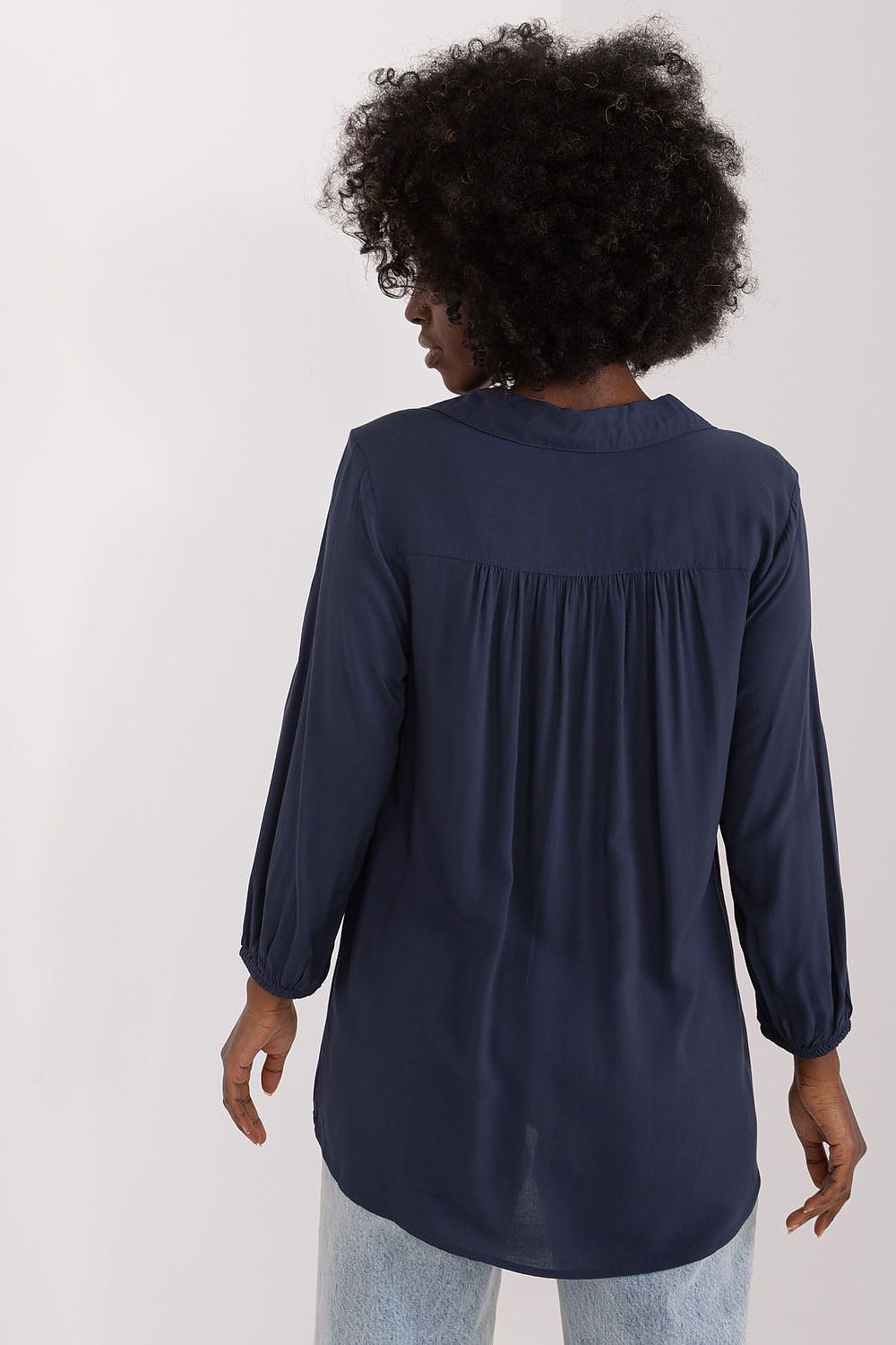 Back view of the elegant everyday blouse by Sublevel, featuring airy viscose fabric and pre-wrist sleeves, showcasing a refined heart neckline and tasteful draping.