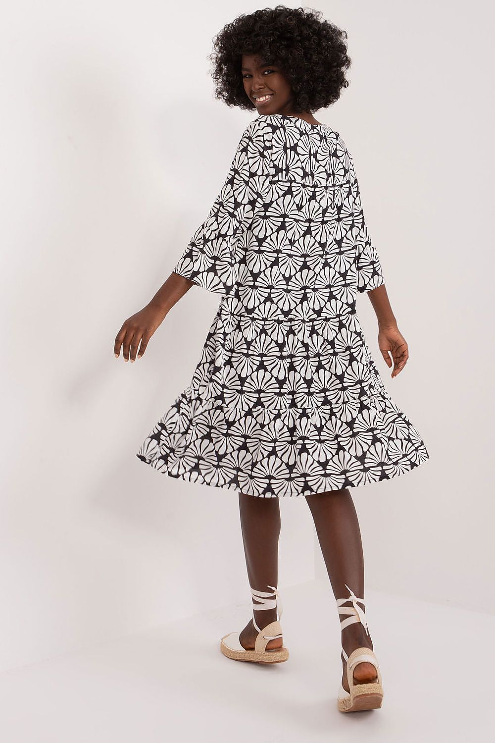 Back view of an elegant summer viscose daydress by Sublevel, showcasing the flowing design and unique floral print, ideal for casual summer events.