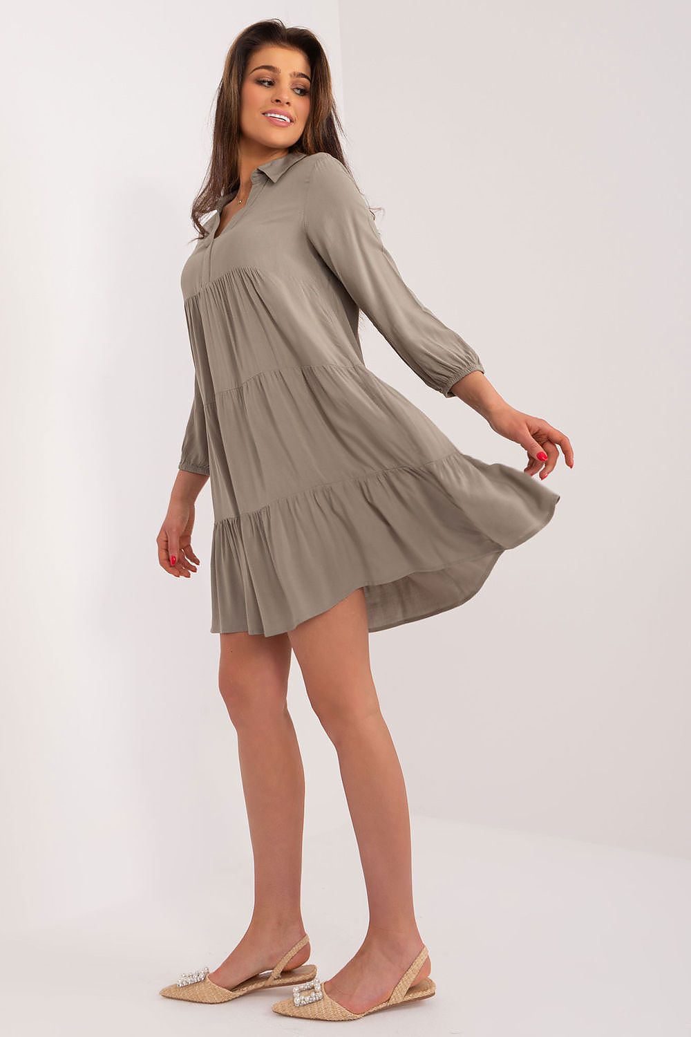Model spinning in a chic khaki oversized summer dress by Sublevel, emphasizing its flowing silhouette and lightweight fabric for a breezy summer look.