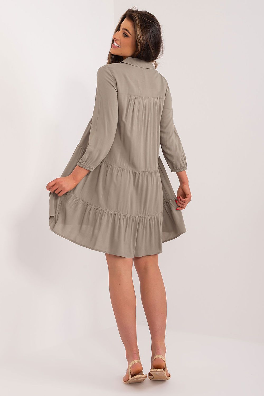 Stylish model wearing a khaki oversized summer dress by Sublevel, highlighting the elegant design and feminine ruffles that enhance its versatile summer appeal.