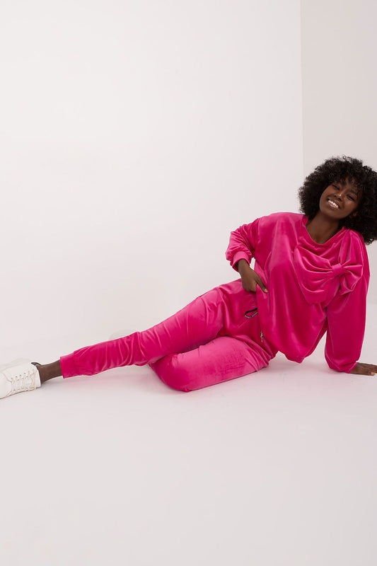 Luxurious Italy Moda velour two-piece sweatshirt and pants set in vibrant pink, featuring stylish drawstrings and a charming bow detail, perfect for elegant, casual comfort.