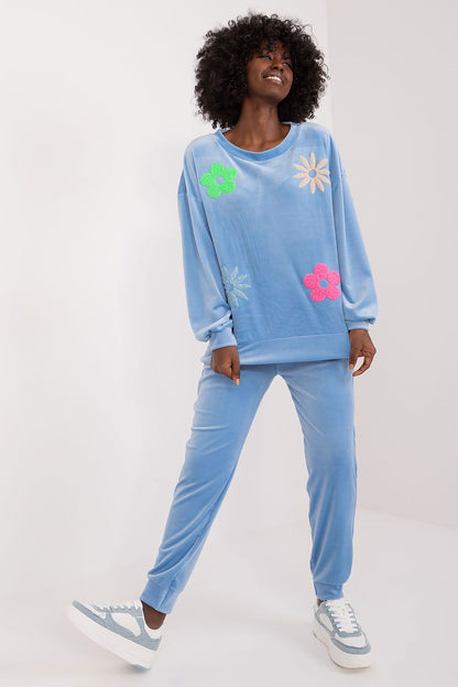 Model wearing a blue elegant floral print velour set by Italy Moda, harmoniously blending comfort and style for a chic casual look.