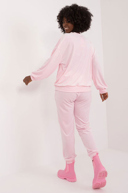Exquisite long sleeve velour set from Italy Moda, featuring a soft pastel pink colour, perfect for casual elegance. Model showcases the stylish set with a relaxed fit, ideal for comfortable lounging.