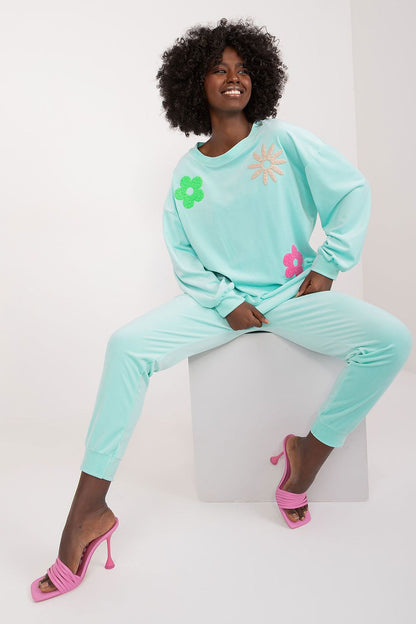 Chic front view of the mint velour set by Italy Moda, highlighting vibrant floral patterns, perfect for a sophisticated yet relaxed summer outfit.