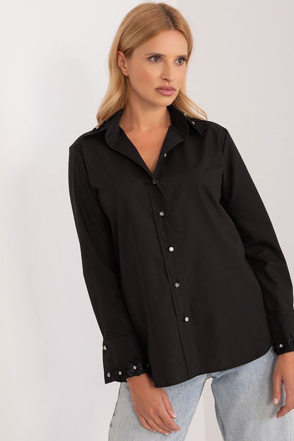 Chic black long sleeve shirt by Lakerta, featuring exquisite embroidered details and zircons on the cuffs, elegantly styled by the model, illustrating a modern luxury aesthetic.