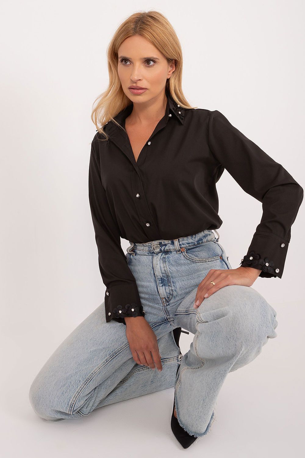A stylish pose of a black long sleeve cotton shirt adorned with embroidered flowers and decorative zircons at the cuffs, designed by Lakerta, perfect for a luxurious wardrobe.
