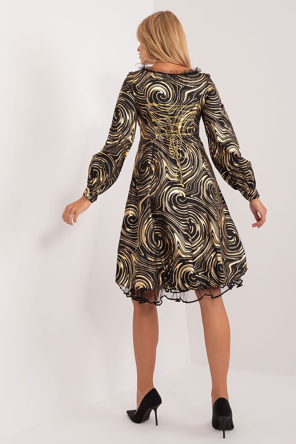 Exquisite Lakerta evening dress in black and gold swirl print, showcasing a flared design and long buff sleeves from a back view, perfect for special events.