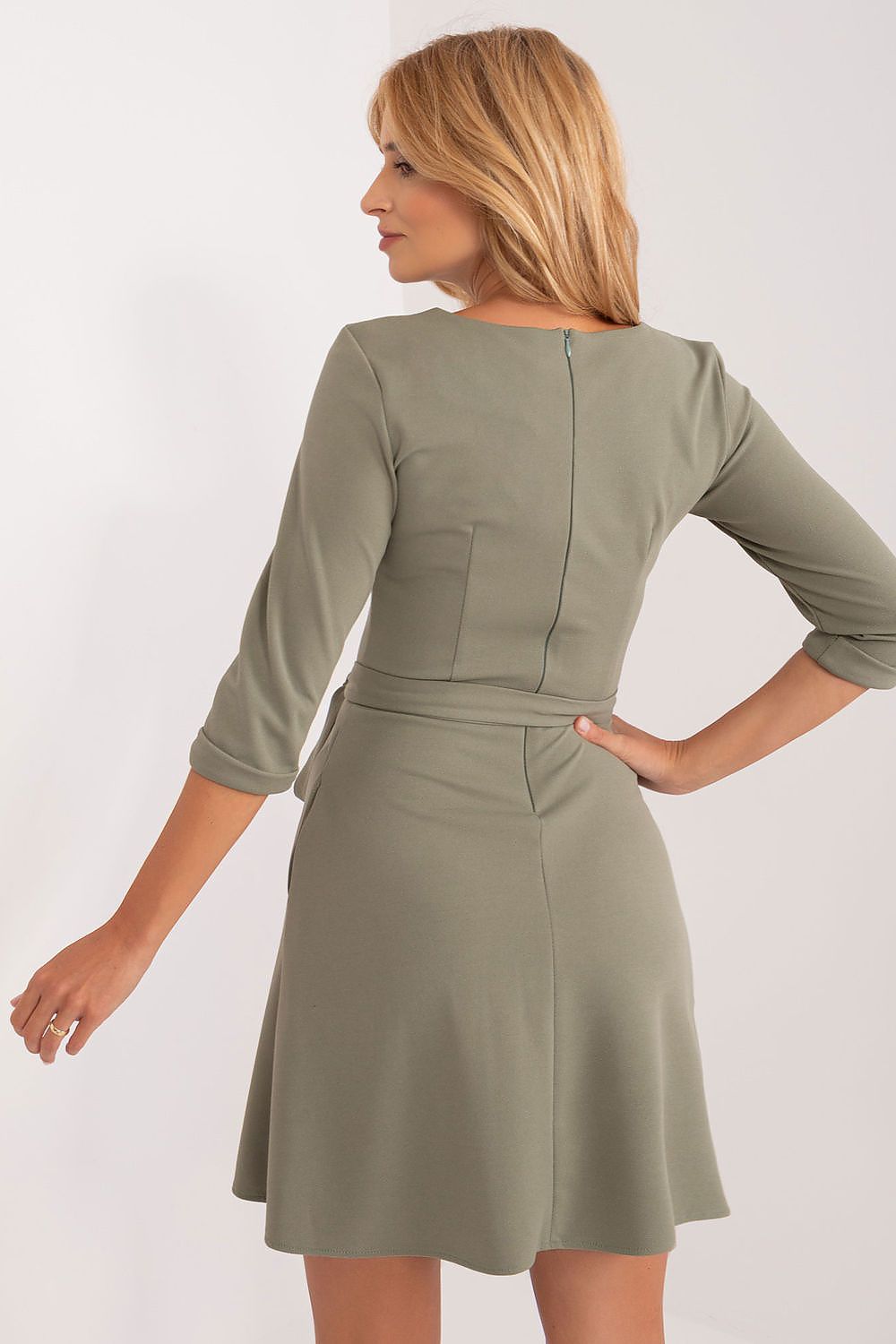 Seductive back view of a flared V-neck dress by Lakerta, displaying its sophisticated cut with a hidden zipper and cinched waist detail.