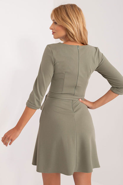 Seductive back view of a flared V-neck dress by Lakerta, displaying its sophisticated cut with a hidden zipper and cinched waist detail.