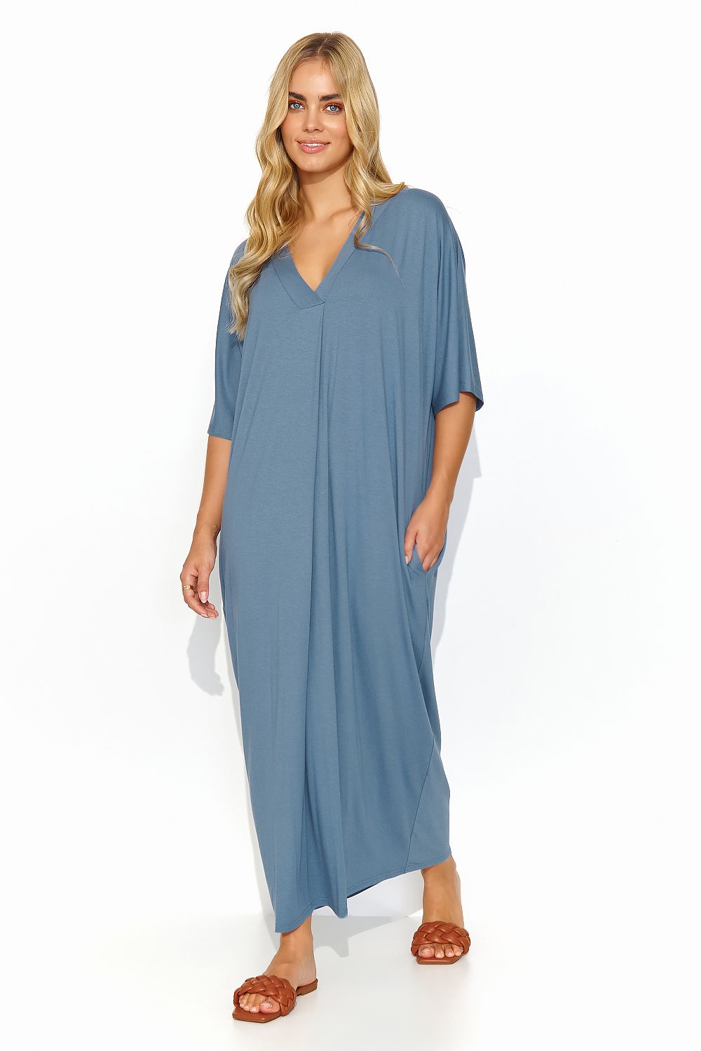 Chic blue Makadamia long dress with a V neckline, elegantly styled on a model, perfect for effortless summer elegance.