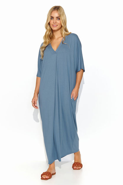 Chic blue Makadamia long dress with a V neckline, elegantly styled on a model, perfect for effortless summer elegance.