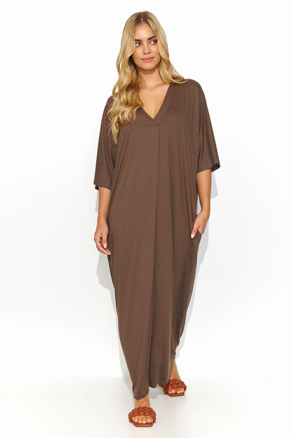 Luxurious brown Makadamia long dress with a stylish V neckline, modeled gracefully, embodying summer sophistication and comfort.