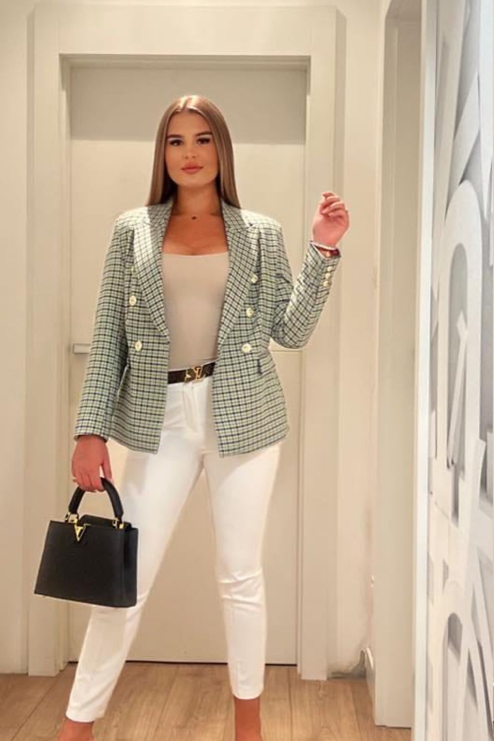 Chic women's blazer jacket by Cabba in a green check pattern, styled with white skinny trousers, perfect for versatile day-to-night wear.