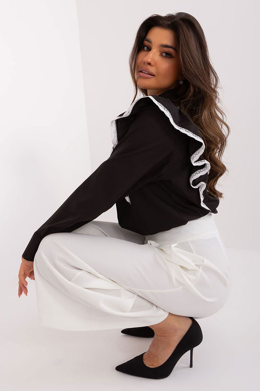 Chic view of Lakerta's black long sleeve cotton shirt with ruffle and lace accents, showcased by a model in a fashionable pose, ideal for business and formal events.
