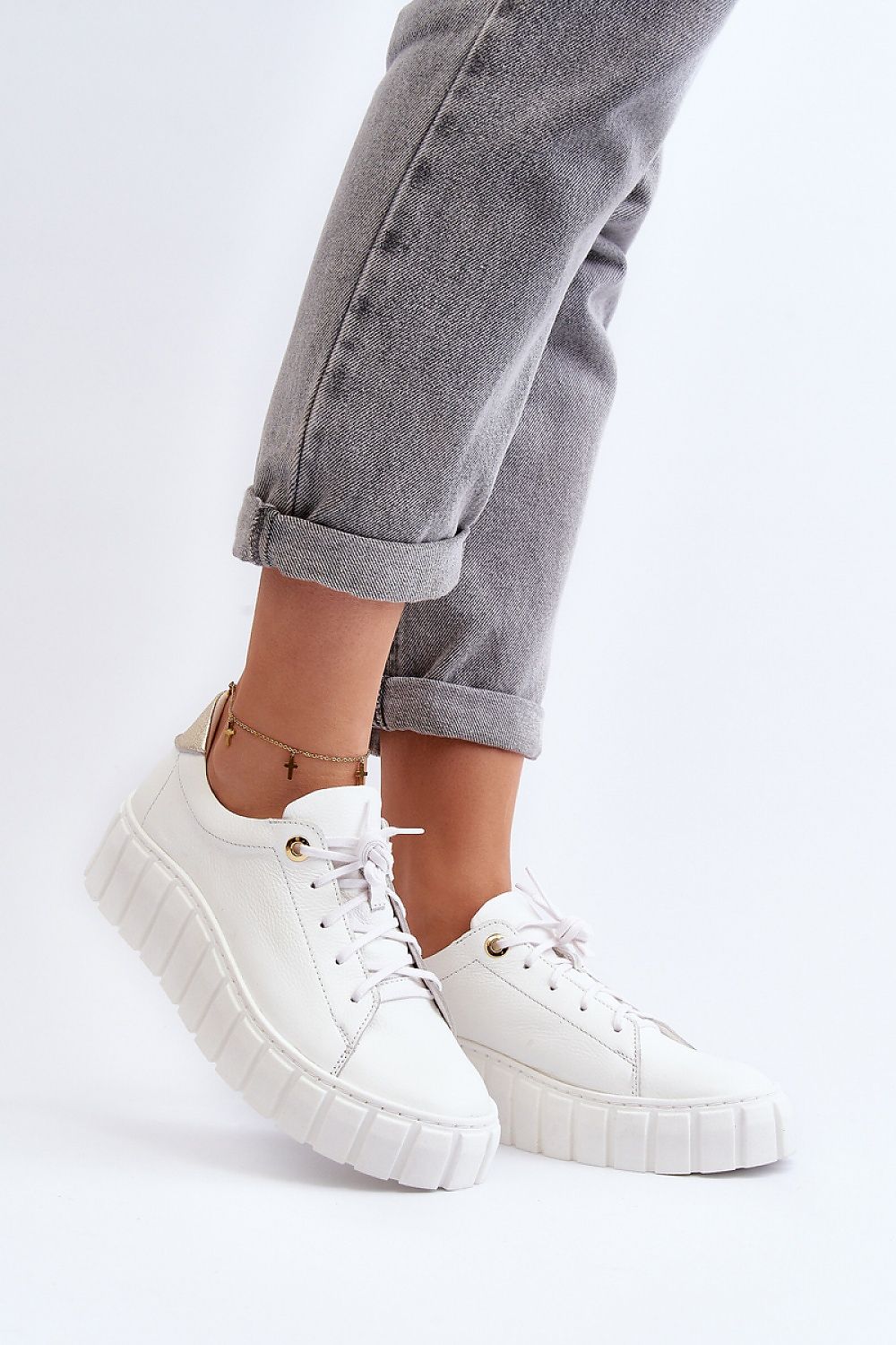 Elegant luxury women's natural leather half shoes by Step in style, featuring a thick rubber platform and classic lacing, perfectly paired with casual grey jeans.
