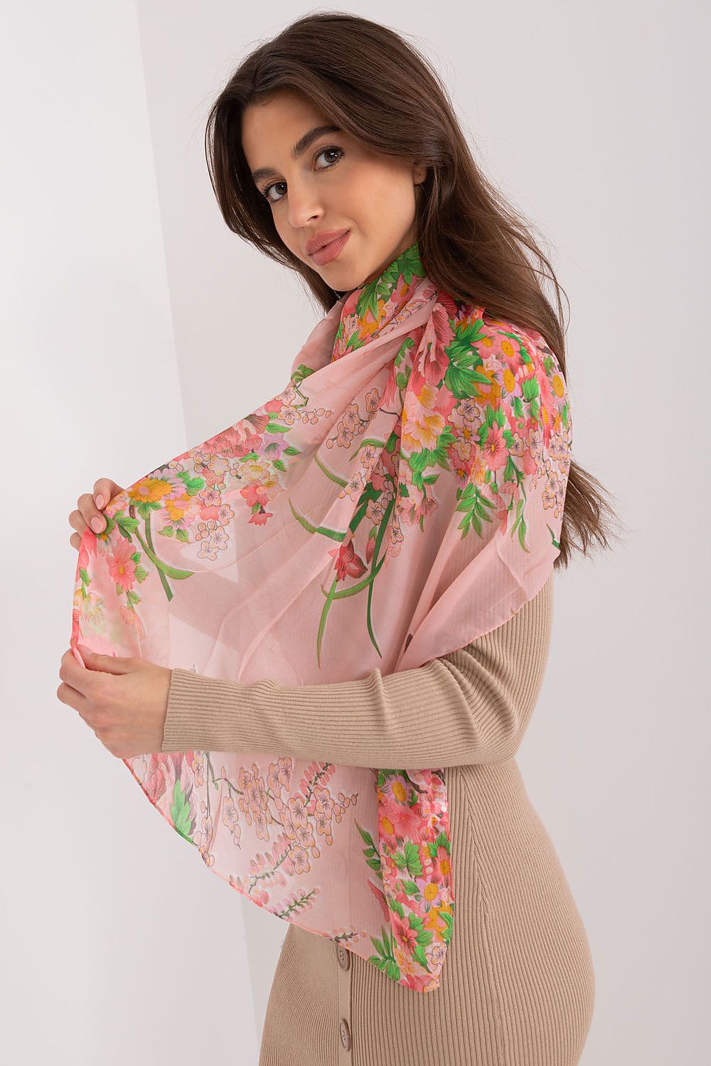 Elegant floral print neckerchief by AT, made from luxury viscose, draped gracefully by a model showcasing its vibrant design and light fabric in a stylish pose.