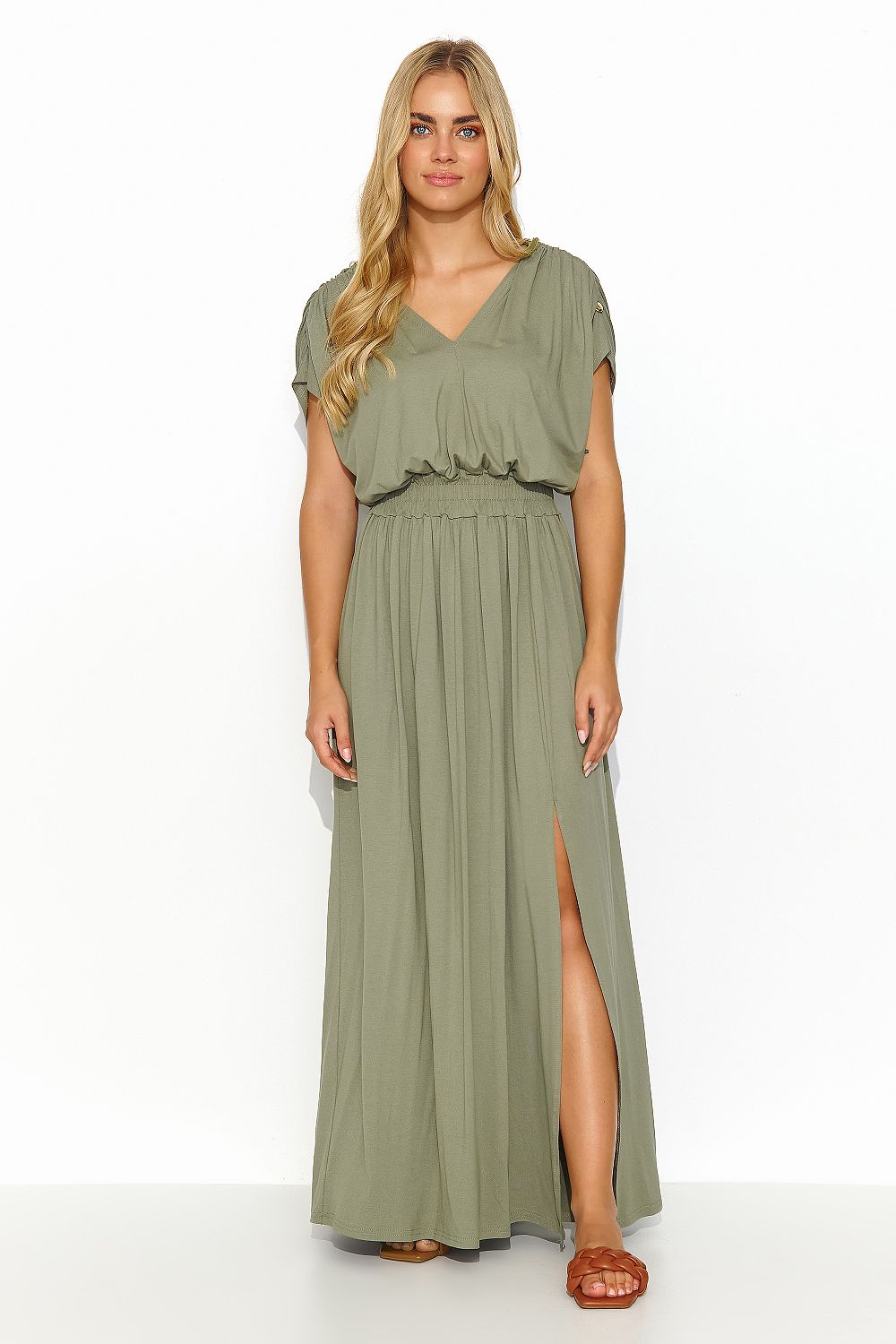Model wearing the olive green Makadamia long lightweight knit daydress, highlighting the graceful front slit and feminine charm suitable for various occasions.