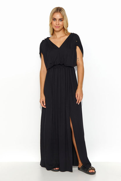 Stylish Makadamia long lightweight knit daydress in classic black, featuring a deep V-neckline and front slit, perfect for both casual and elegant summer events.