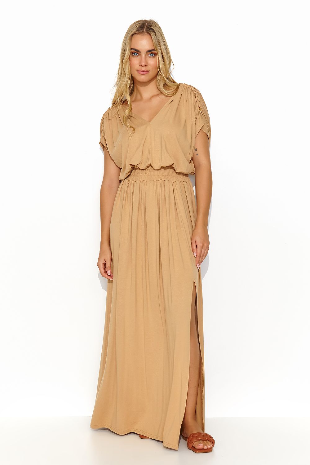 Elegant woman modeling the Makadamia long lightweight knit daydress in taupe, featuring a heart neckline and stylish draping, perfect for summer occasions.