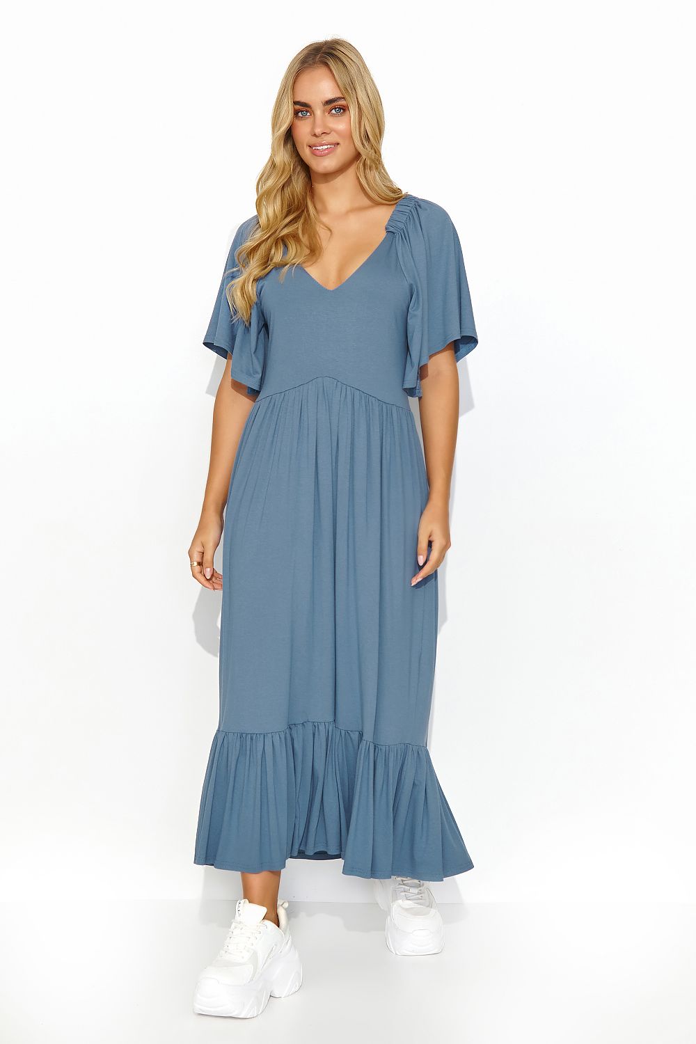 Elegant long ruffle dress in blue by Makadamia, featuring a deep-cut neckline and feminine silhouette, perfect for summer occasions.