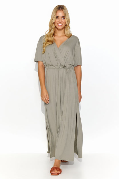 Elegant long Makadamia daydress in soft olive green, featuring a tie waist, short sleeves, and heart neckline, perfect for chic summer outings.