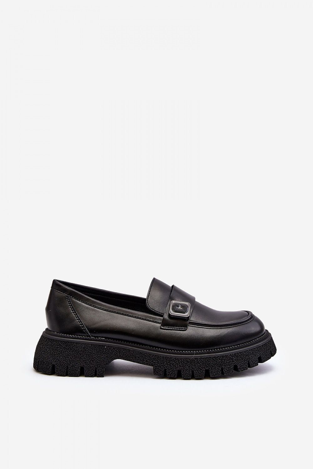 Close-up of Step in Style eco-suede moccasins showcasing a stylish strap and robust flat sole, perfect for sophisticated outings this spring.