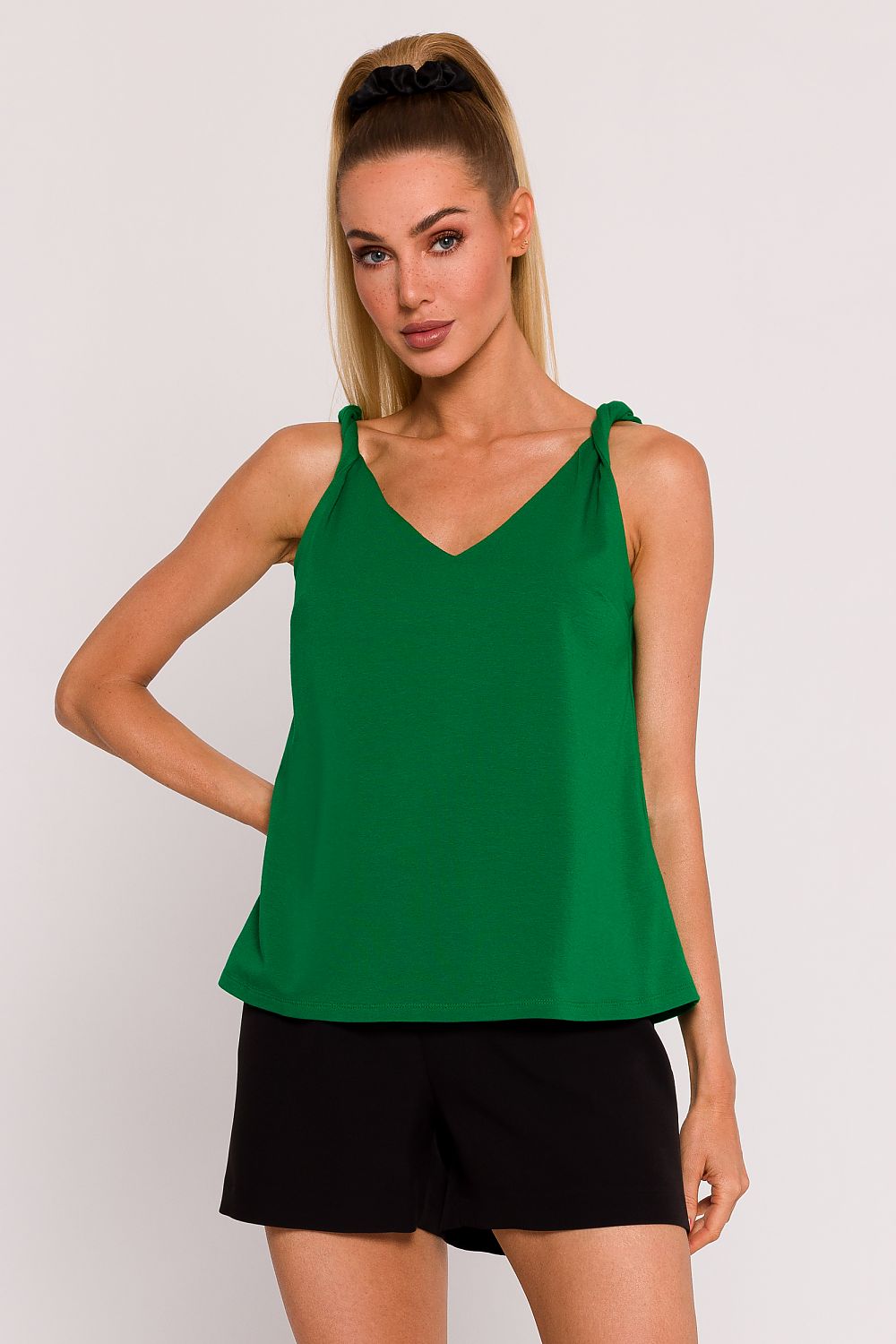 Elegant knitted blouse by Moe featuring a delicate V-neckline, crafted in Poland. The unique back cut adds a touch of sensuality, ideal for sophisticated looks.