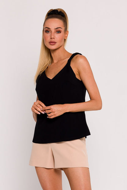 Detail of the exquisite back cut on a knitted blouse by Moe, showcasing its unique design and artisanal craftsmanship.