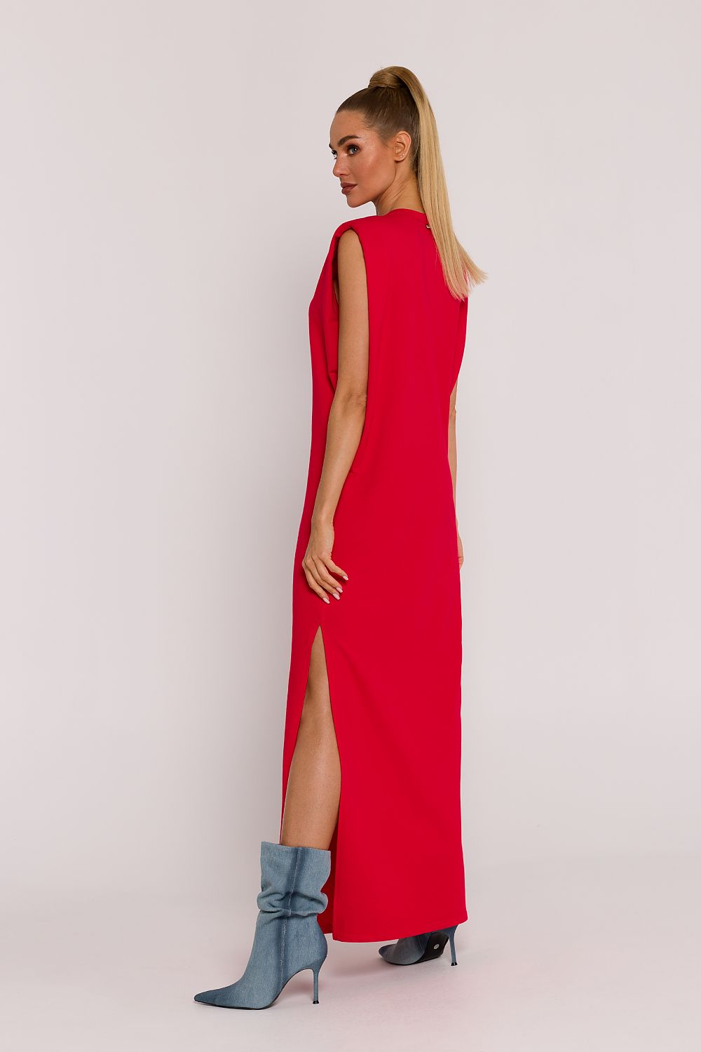 Side view of Moe's luxury oversized knit dress, emphasizing the flattering silhouette and unique shoulder pads.
