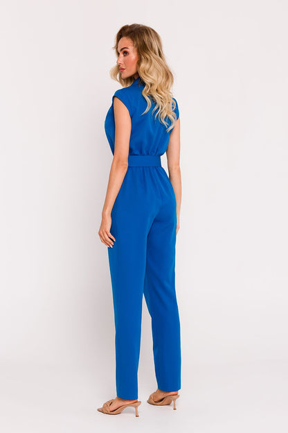 Elegant Polish tailored jumpsuit by Moe featuring a sophisticated asymmetrical design and a stylish belted waist.