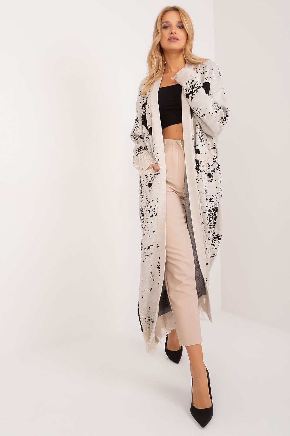 Elegant ankle-length cardigan by Badu in soft acrylic, featuring a unique print and practical pockets, perfect for a stylish yet comfortable look.