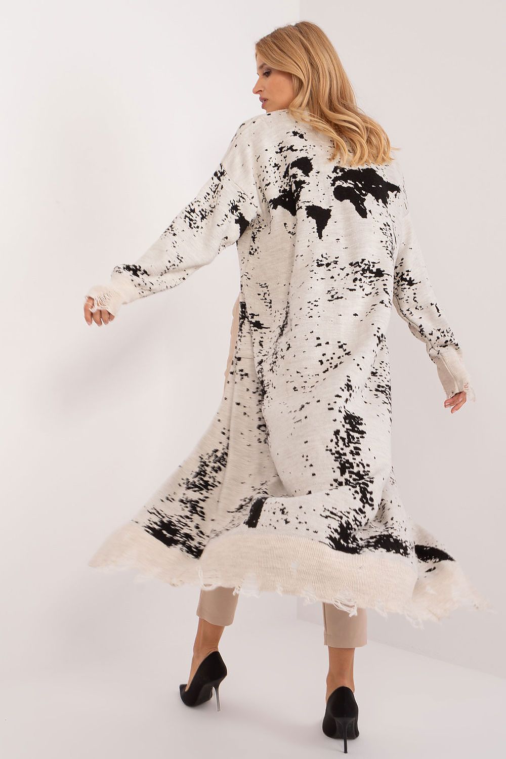 Badu's stylish ankle-length cardigan displayed draped elegantly, highlighting its warm material and practical pockets, ideal for casual or work settings.