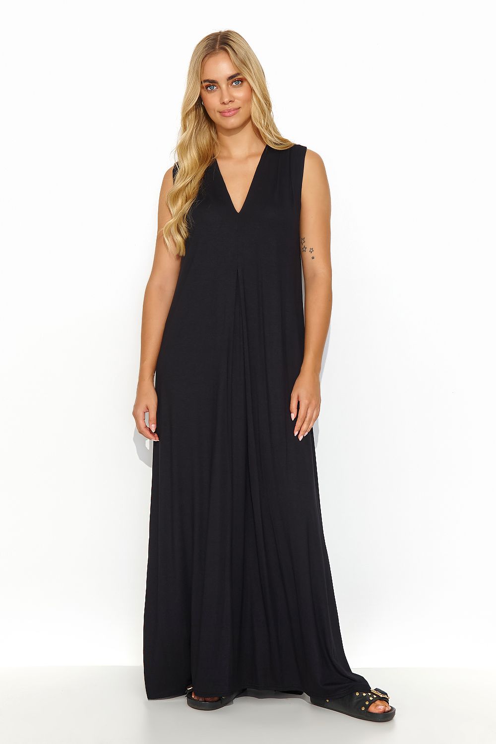 Chic Makadamia loose maxi dress showcasing slits and a gold plate detail at the back, designed for stylish summer outings.