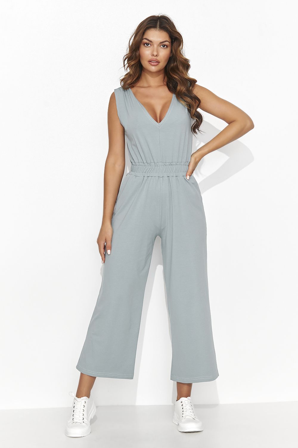 Chic Numinou Women's Knit Jumpsuit showcasing wide shoulder straps and practical side pockets, ideal for a fashionable and comfortable summer look.