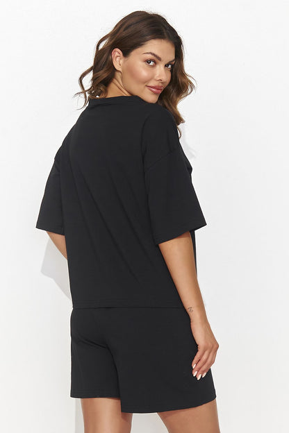 Chic and sporty Numinou women's ensemble showcasing loose shorts and a beautifully designed blouse, perfect for versatile fashion styling.