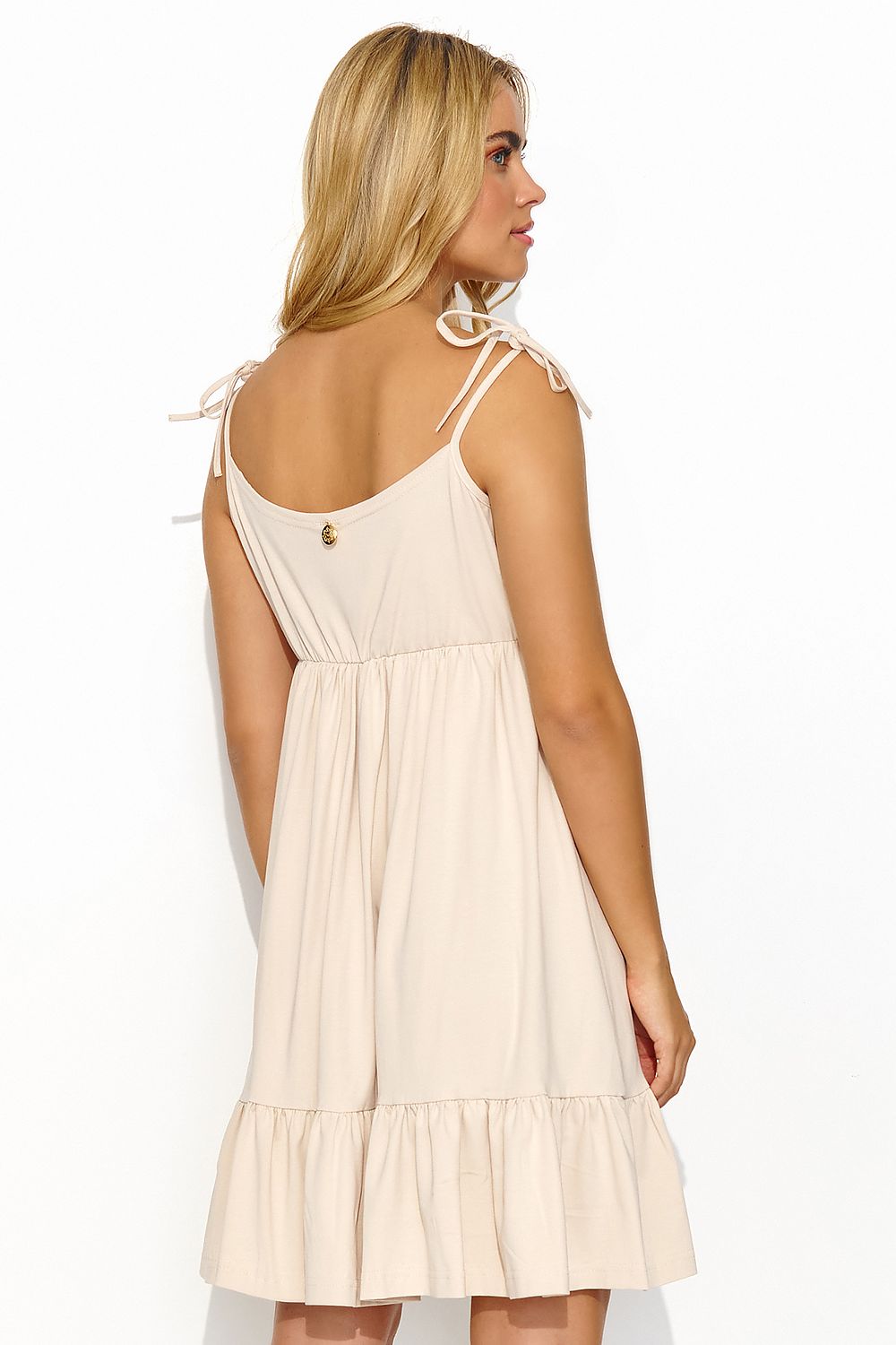 Model wearing Makadamia's elegant summer dress with ruffled hem, embodying a blend of comfort and style perfect for warm weather.