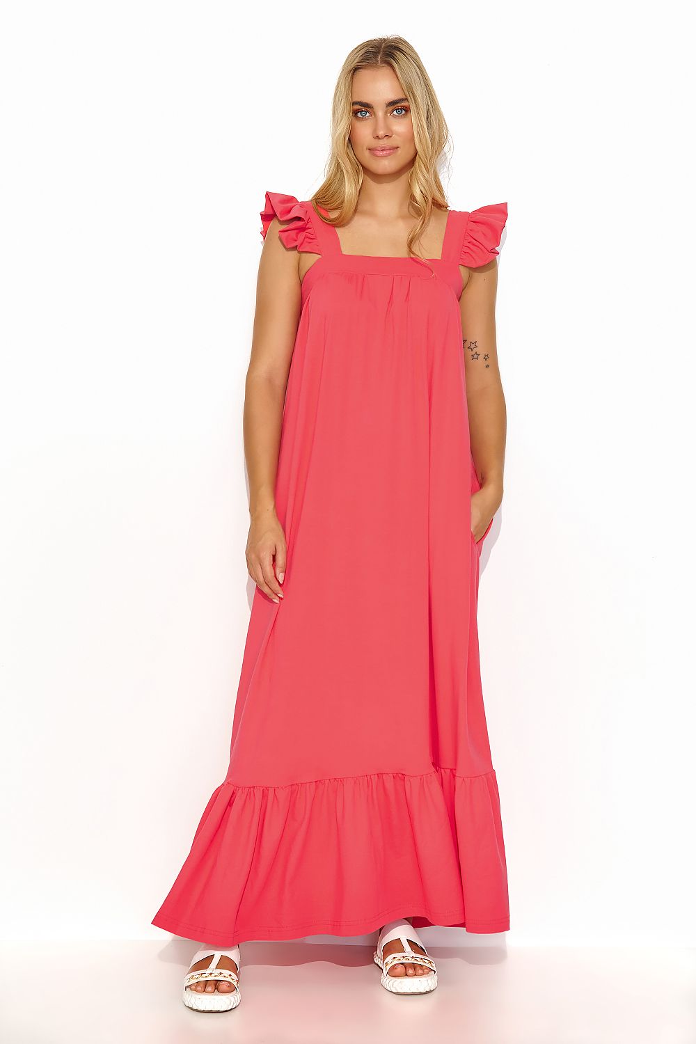 Side view of the Makadamia Summer Maxi Dress showcasing its comfortable loose fit and practical side pockets, ideal for upscale events.