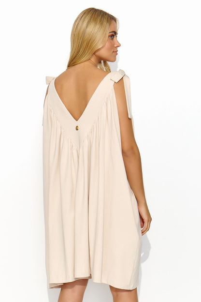 Model wearing a Makadamia summer maxi dress with a flattering silhouette and deep V-neck, showcasing its comfort and sophistication for summer events.