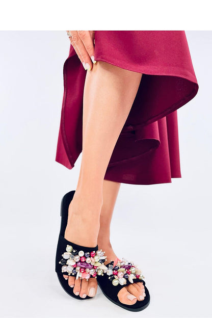 Elegant display of Inello eco-friendly women's flip-flops, adorned with vibrant stones, highlighting summer fashion trends.