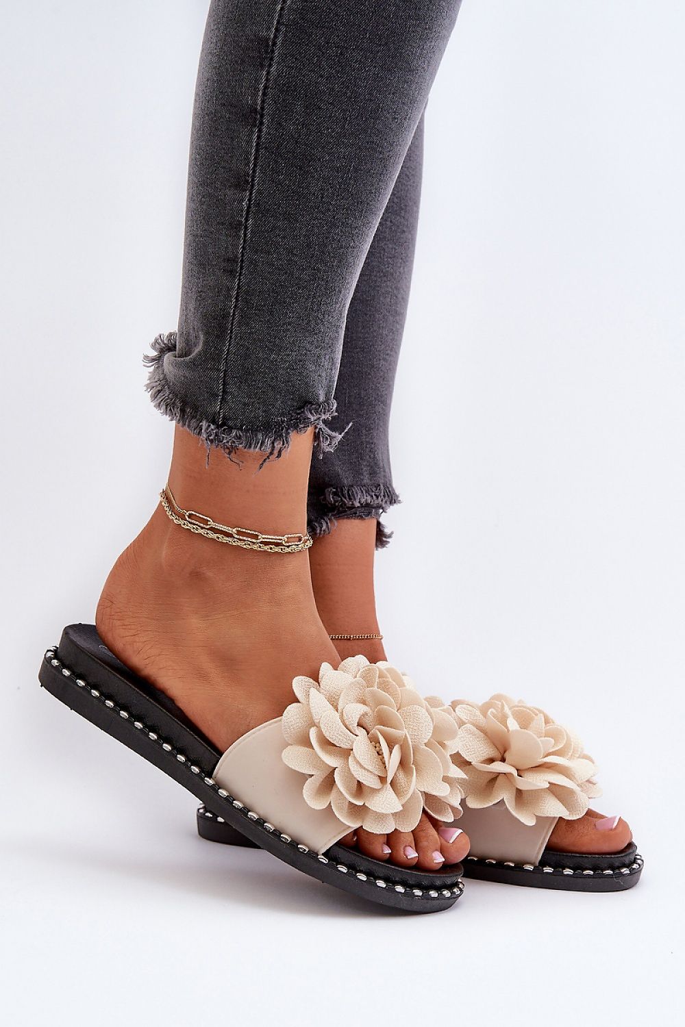 Side view of Step in Style women's flip-flops, designed with eye-catching front details and a durable rubber sole for fashionable summer outings.