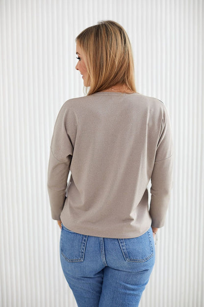 Close-up of La Aurora's kimono style blouse featuring drooping sleeves, highlighting the fine texture of the viscose knit material in an elegant and sophisticated setting.