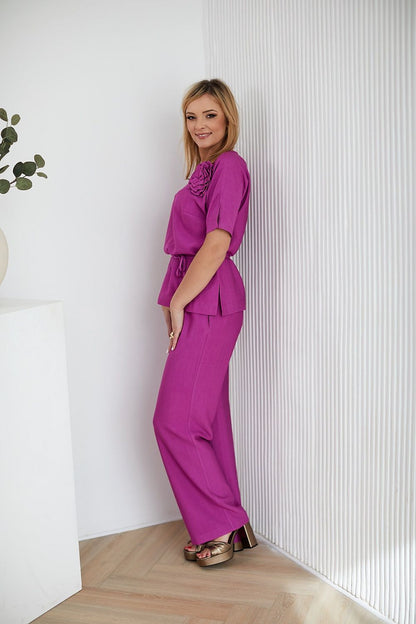 Luxury La Aurora women's clothing set displayed on a model, highlighting the versatility of the blouse and pants for various occasions.