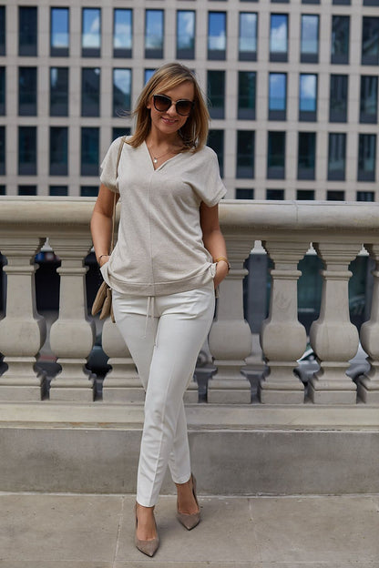 Close-up view of the soft viscose knit fabric of La Aurora's luxury kimono blouse, highlighting the intricate gold thread weave.