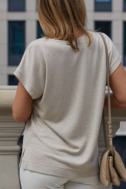 Stylish model showcasing La Aurora's luxury kimono style blouse, perfect for elegant occasions, featuring a flattering fit and gold thread accents.