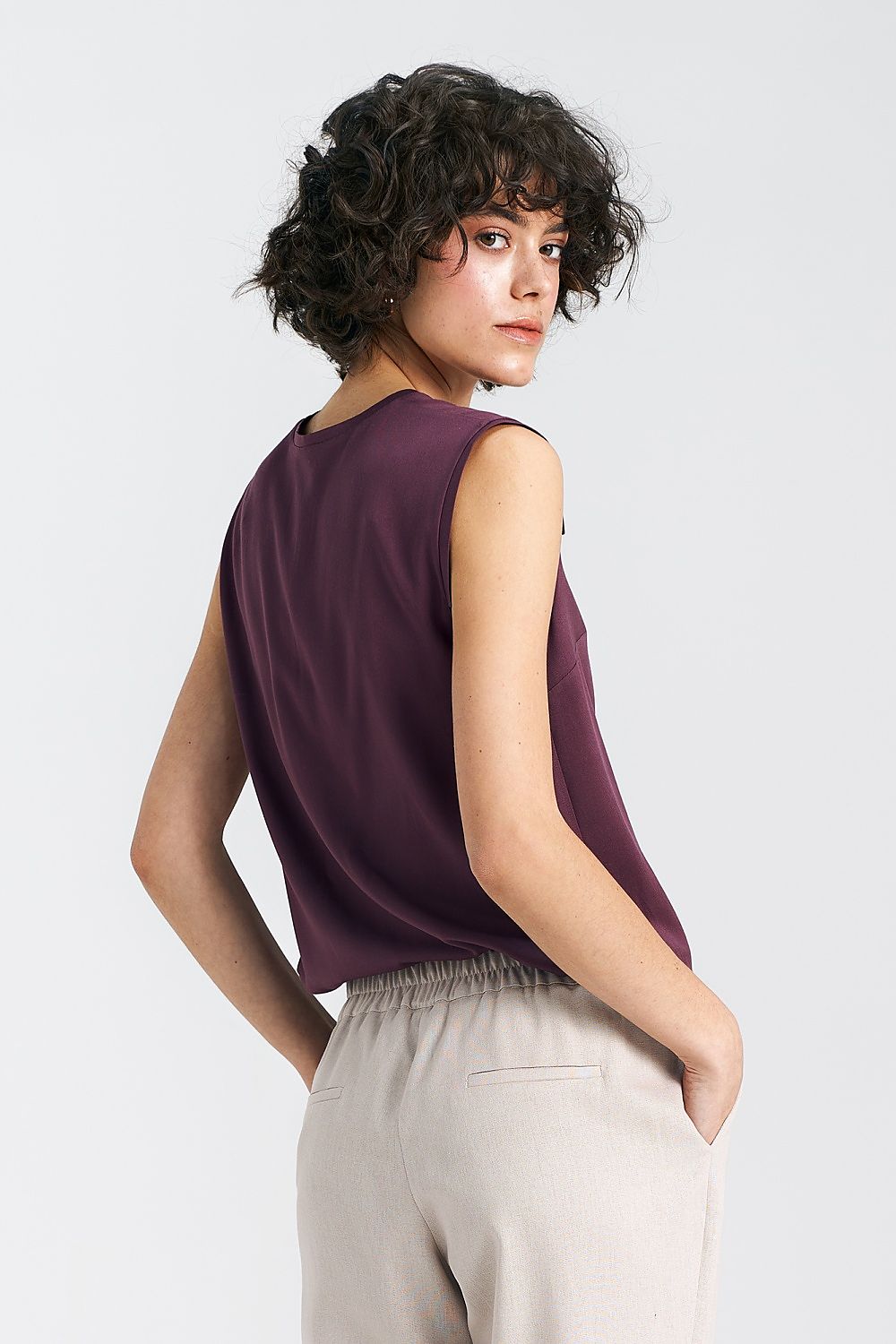 Nife's elegant plum blouse with a deep V-neck and subtle pleat, embodying comfort and sophistication in premium viscose fabric.