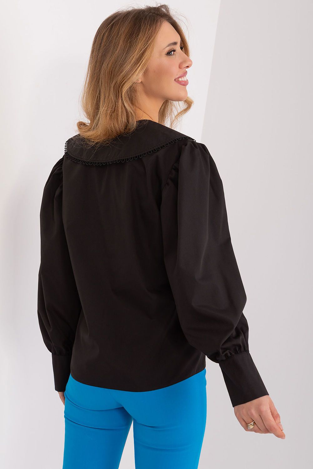 A stylish model wearing Lakerta's elegant women's cotton long sleeve shirt, demonstrating versatility in a chic outfit.