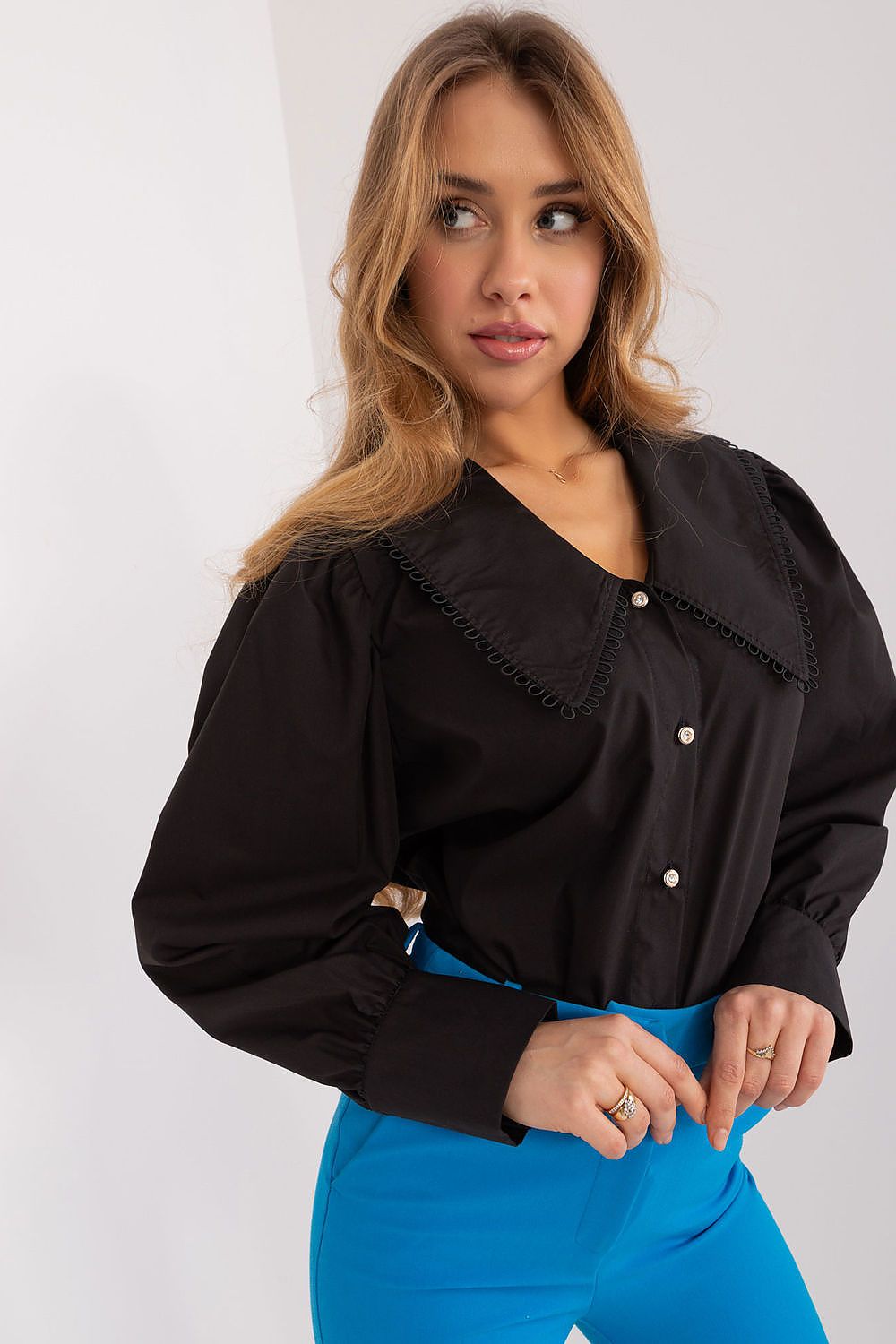 The luxurious cotton fabric of Lakerta's women's shirt highlighted, emphasizing comfort and elegance.