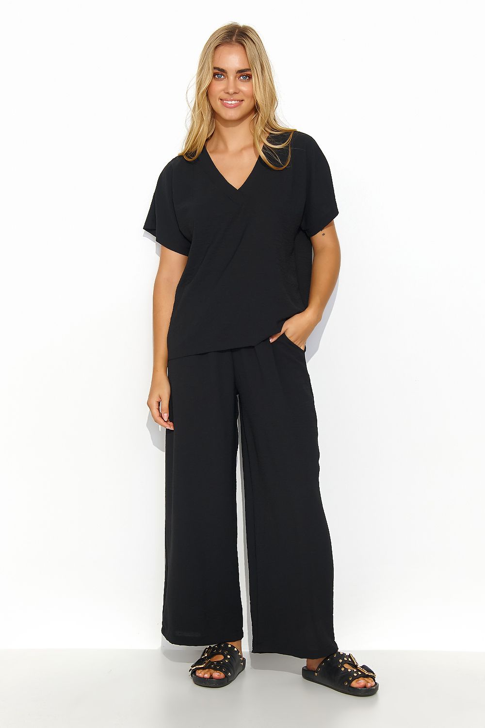Luxury women's 2-piece set by Makadamia showcasing a V-neck blouse paired with elegant wide-leg trousers in classic black.