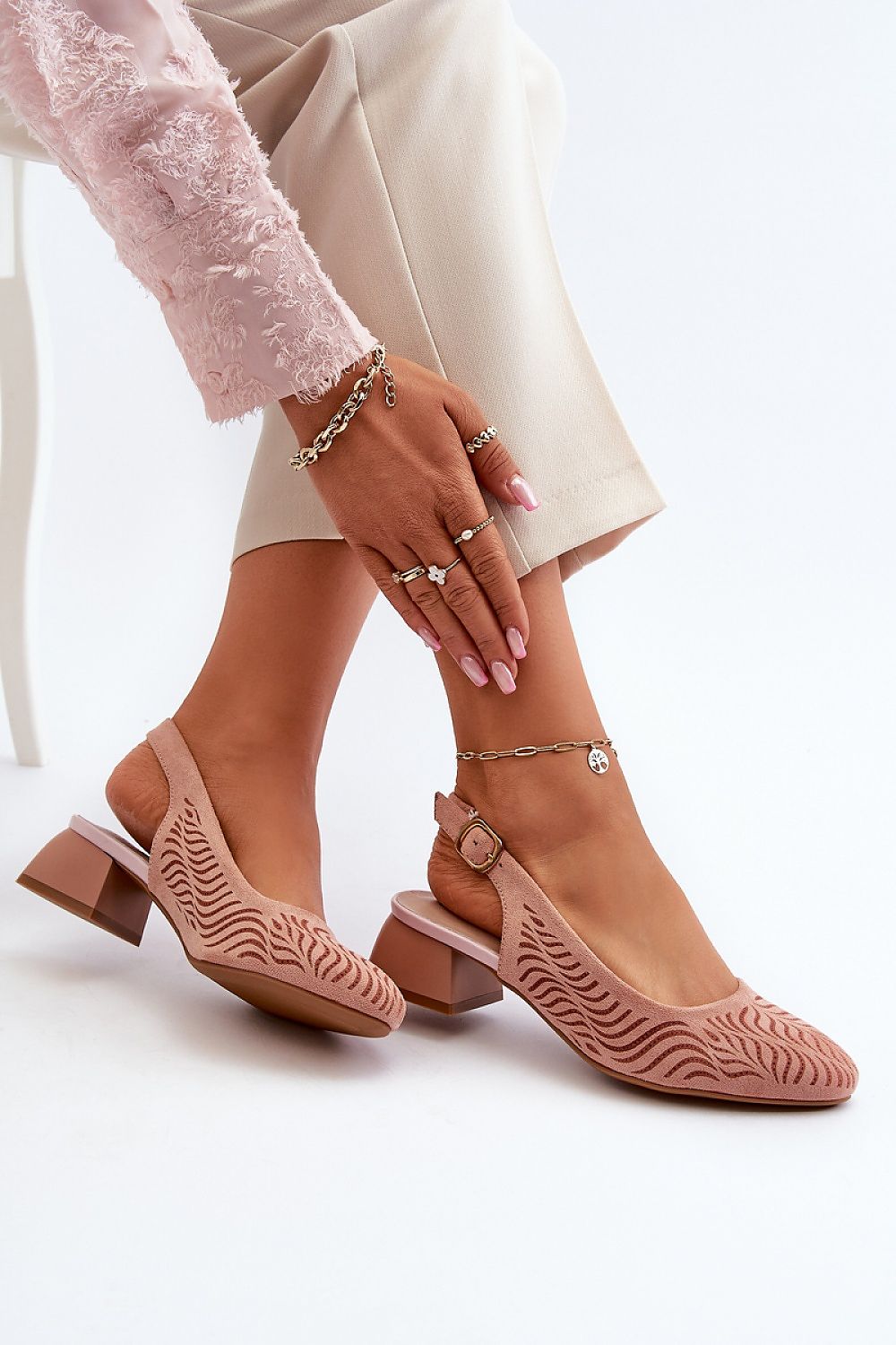 Elegant Jezzi heel pumps from Step in Style, featuring adjustable strap, block heel, and stylish design, showcased in a chic setting.